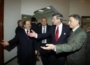 U.S. administrator Paul Bremer, red tie, and Yonadam Kanna, right